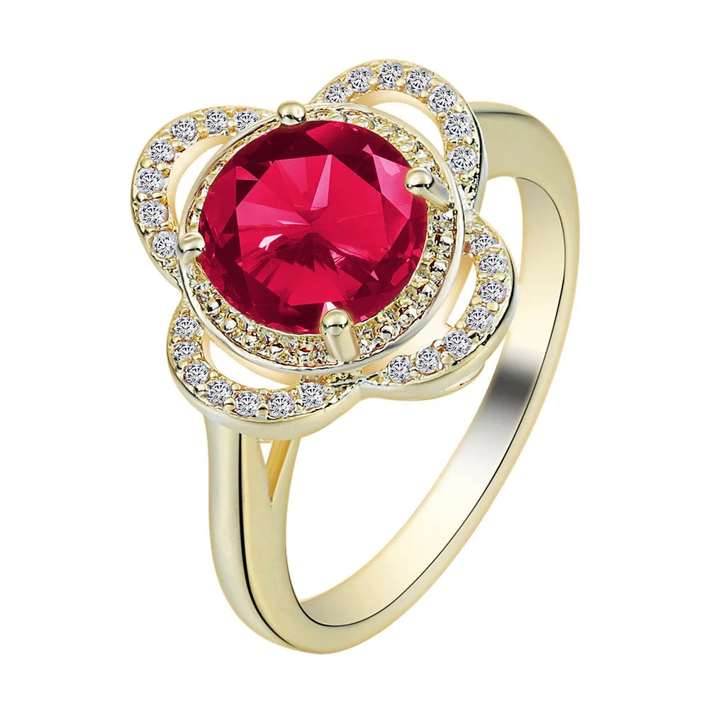 Copper ring with fruit-shaped setting holding a faceted zircon stone.