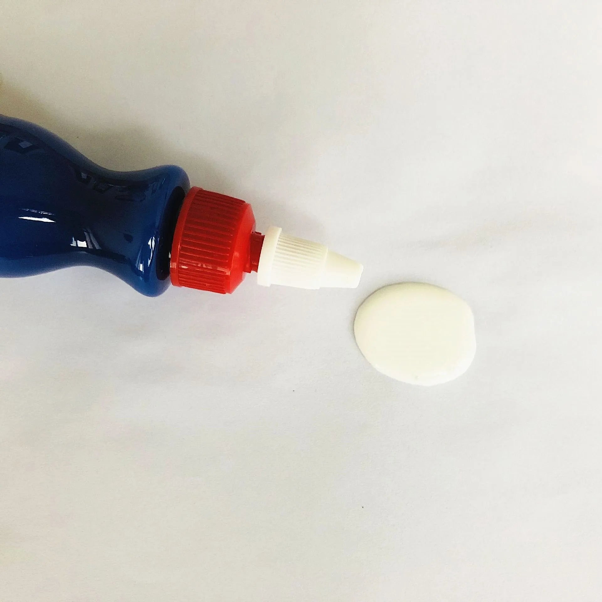 Small blue automotive scratch repair kit with repair agent bottle and applicator sponge for car paint damage