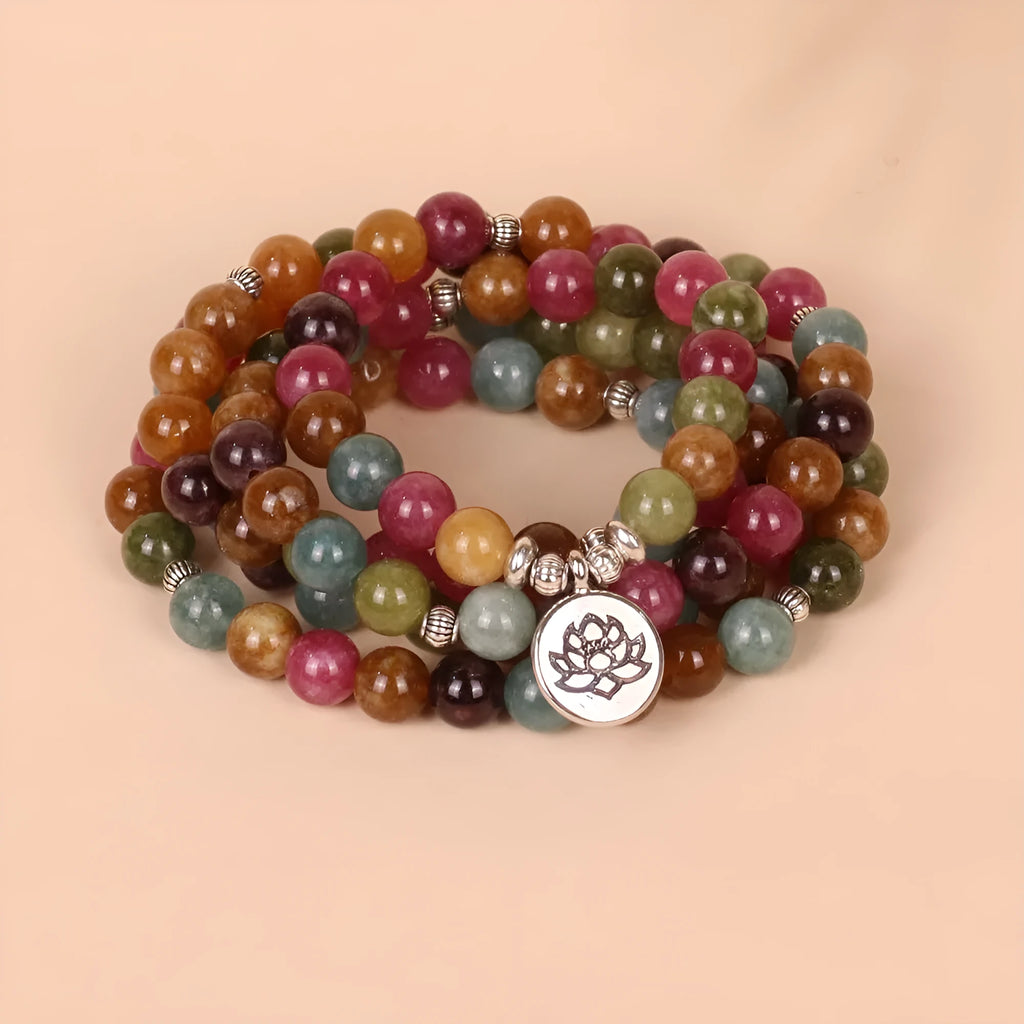 108-bead multi-layer alloy bracelet in a tourmaline colour, shown hanging and as worn jewellery.
