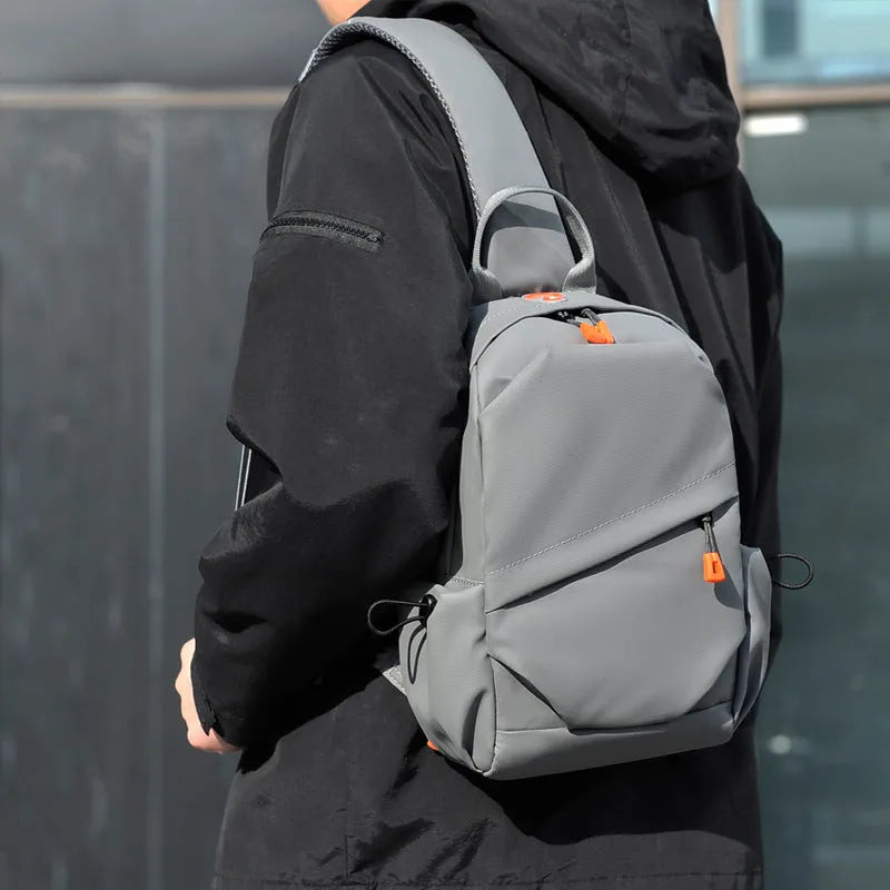 A black men's single shoulder crossbody bag made from polyester fabric.