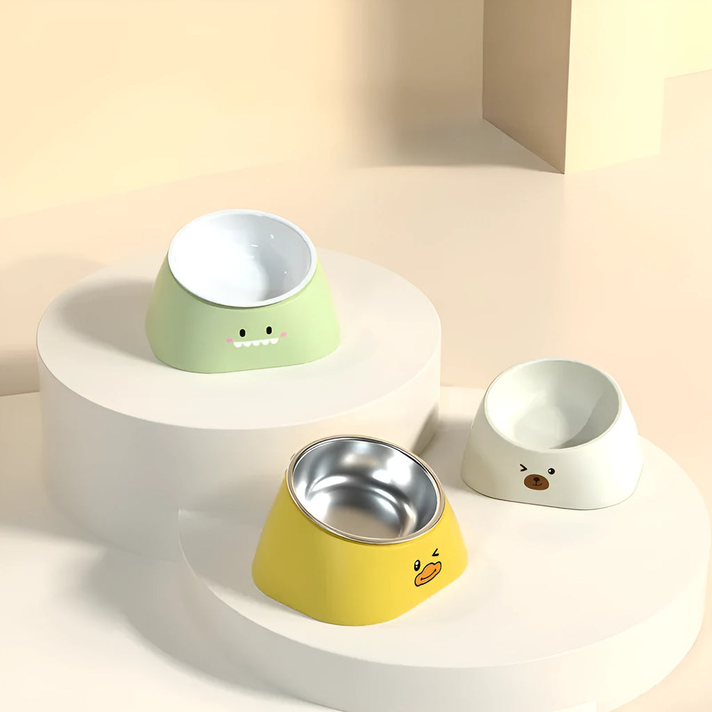 Green tilted pet feeding bowl with stainless steel insert and plastic base for cats and dogs.