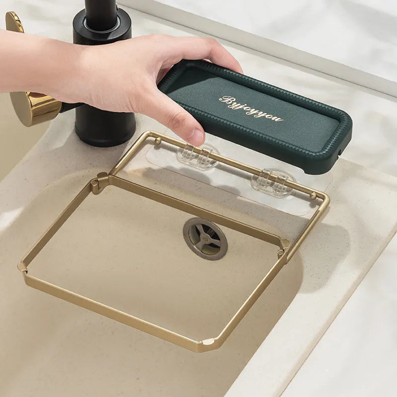 Foldable sink filter rack in dark green gold with disposable mesh bag on a stainless steel sink