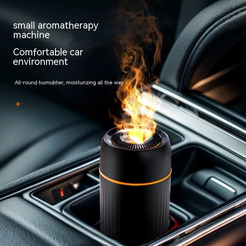 Car aroma diffuser with simulated flame effect showing black unit with mist output