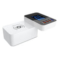 White multi-port USB and wireless fast charger with international plug adapters on a desk