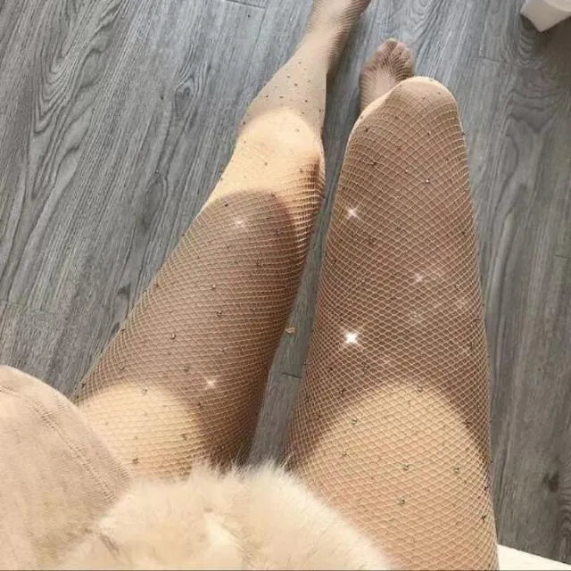 Solid colour fishnet stockings made from thin nylon mesh in skin colour, black, or white.