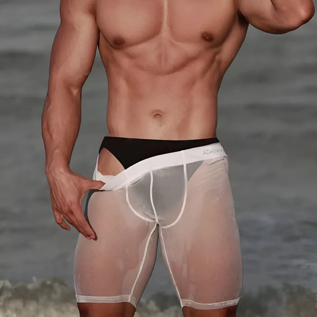 Men's black knitted nylon mesh home shorts on a hanger, showing seamless design.
