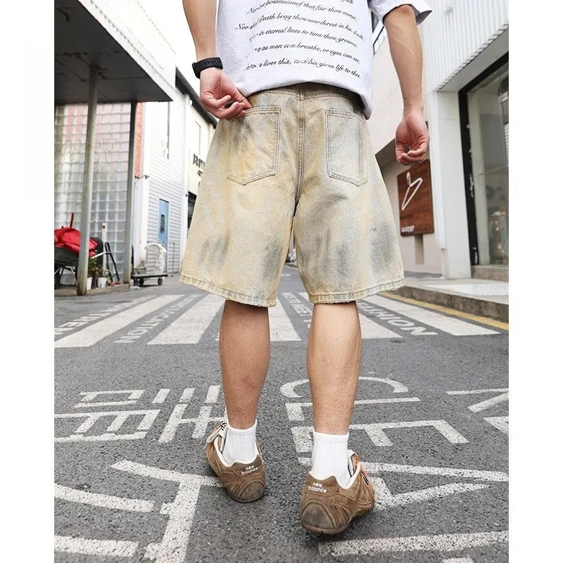Light blue men's denim shorts with a washed finish and ripped detailing on a straight-leg cut.