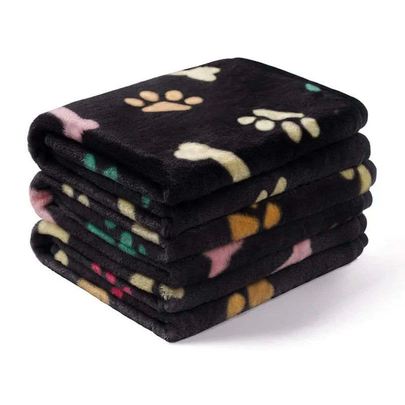 Soft cloth pet blanket with confetti bone and paw print pattern in beige colour on a light background