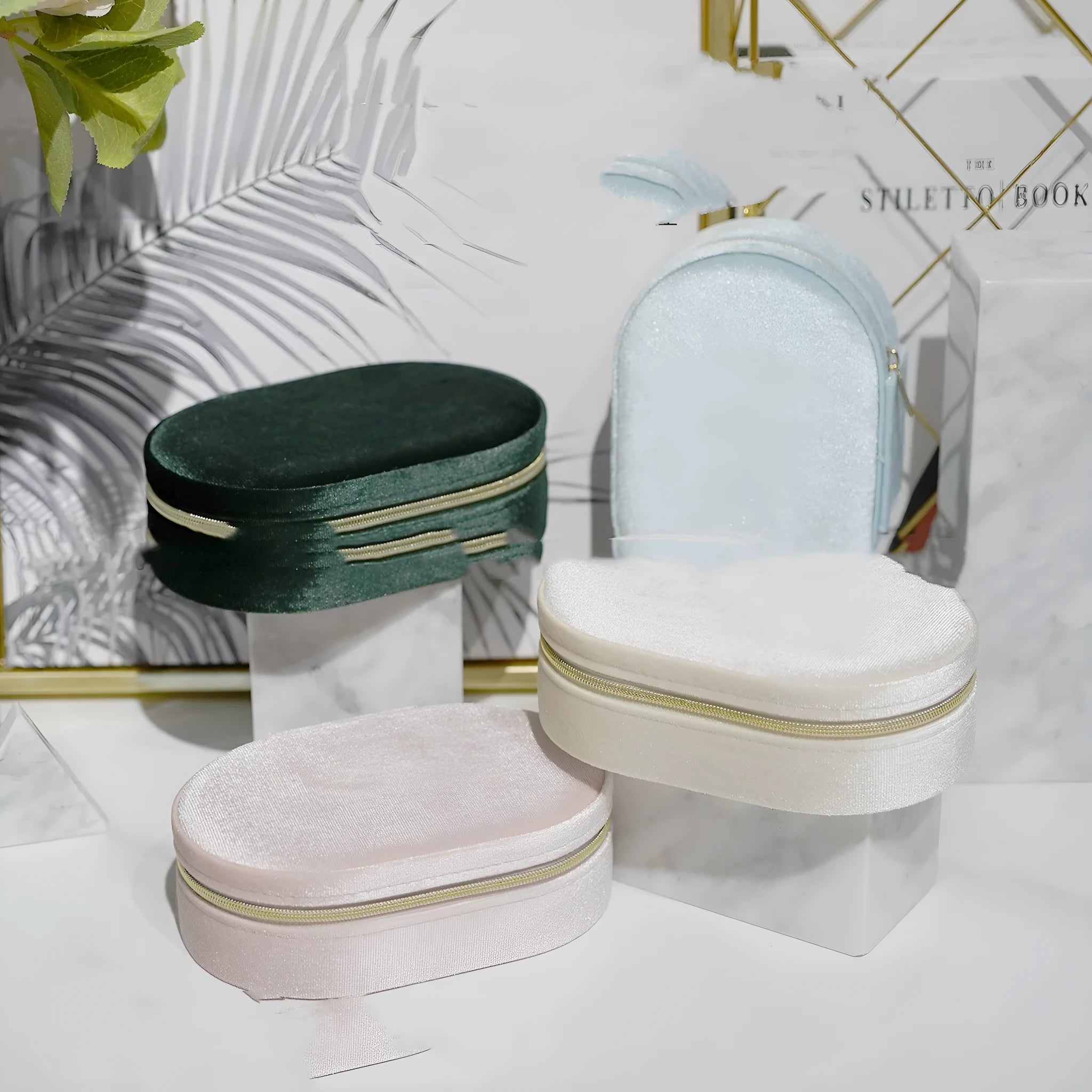 Oval velvet jewellery storage box in lake blue colour with flannel interior and internal hooks.