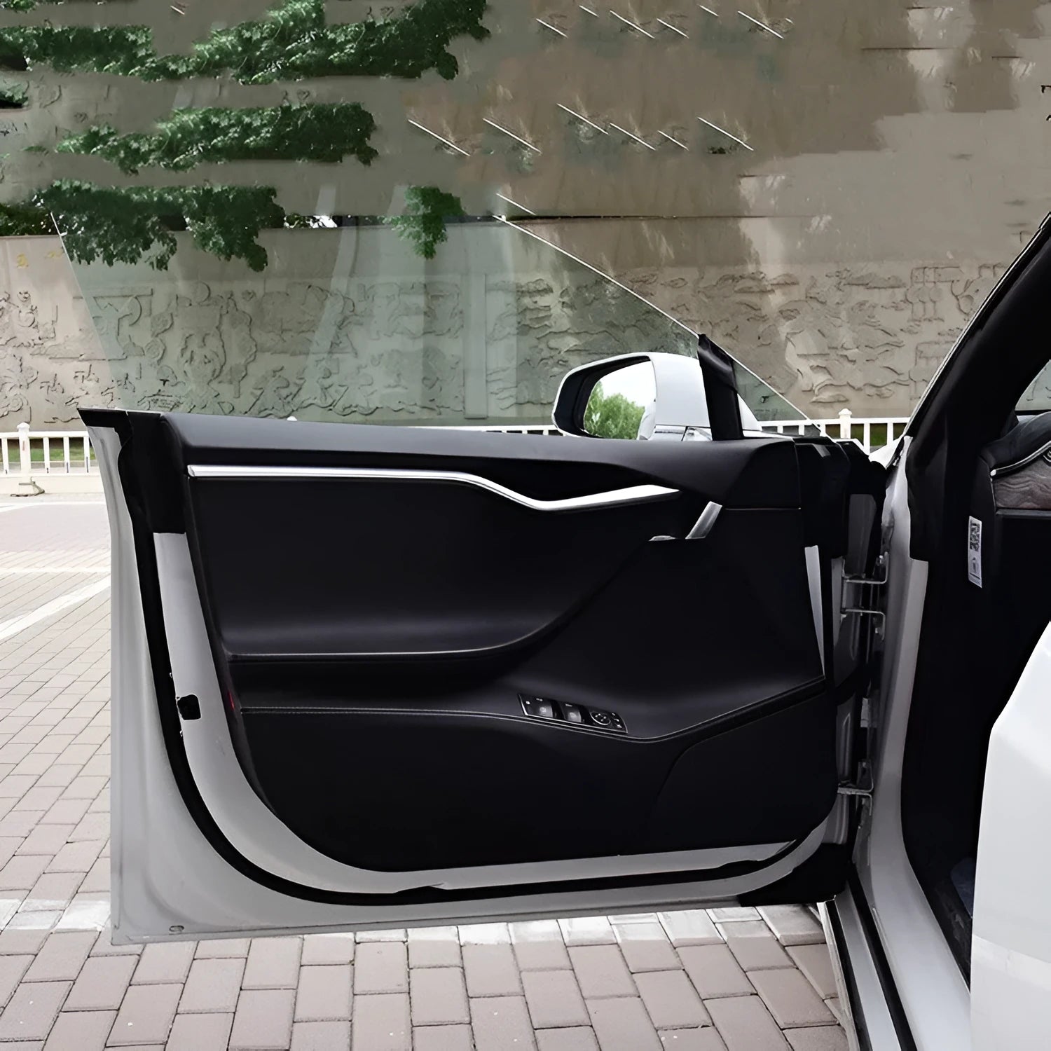 Four carbon fibre protective film pieces for Tesla Model S interior door panels.