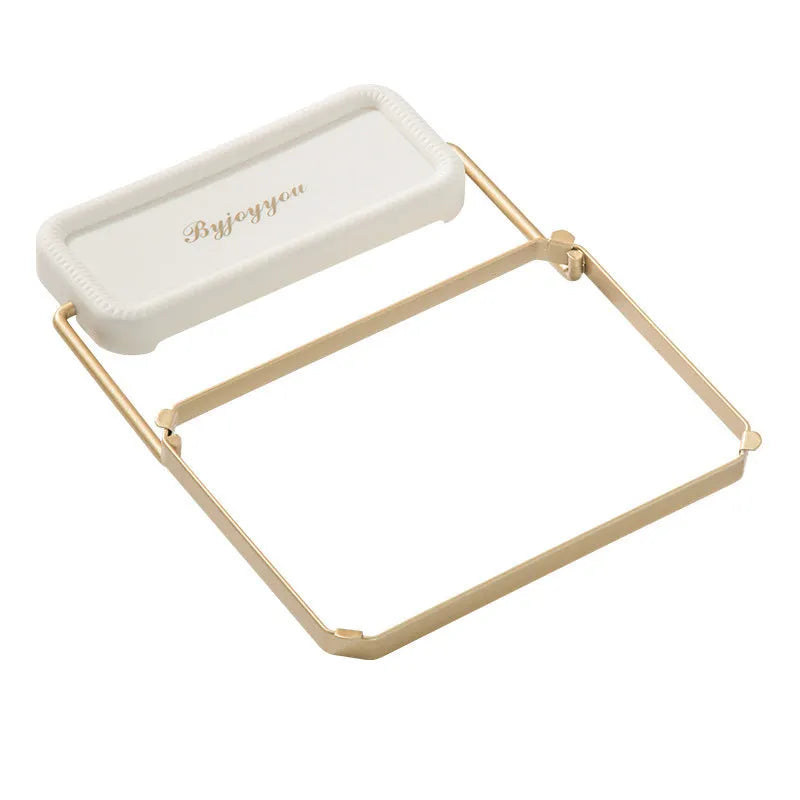 Foldable sink filter rack in dark green gold with disposable mesh bag on a stainless steel sink