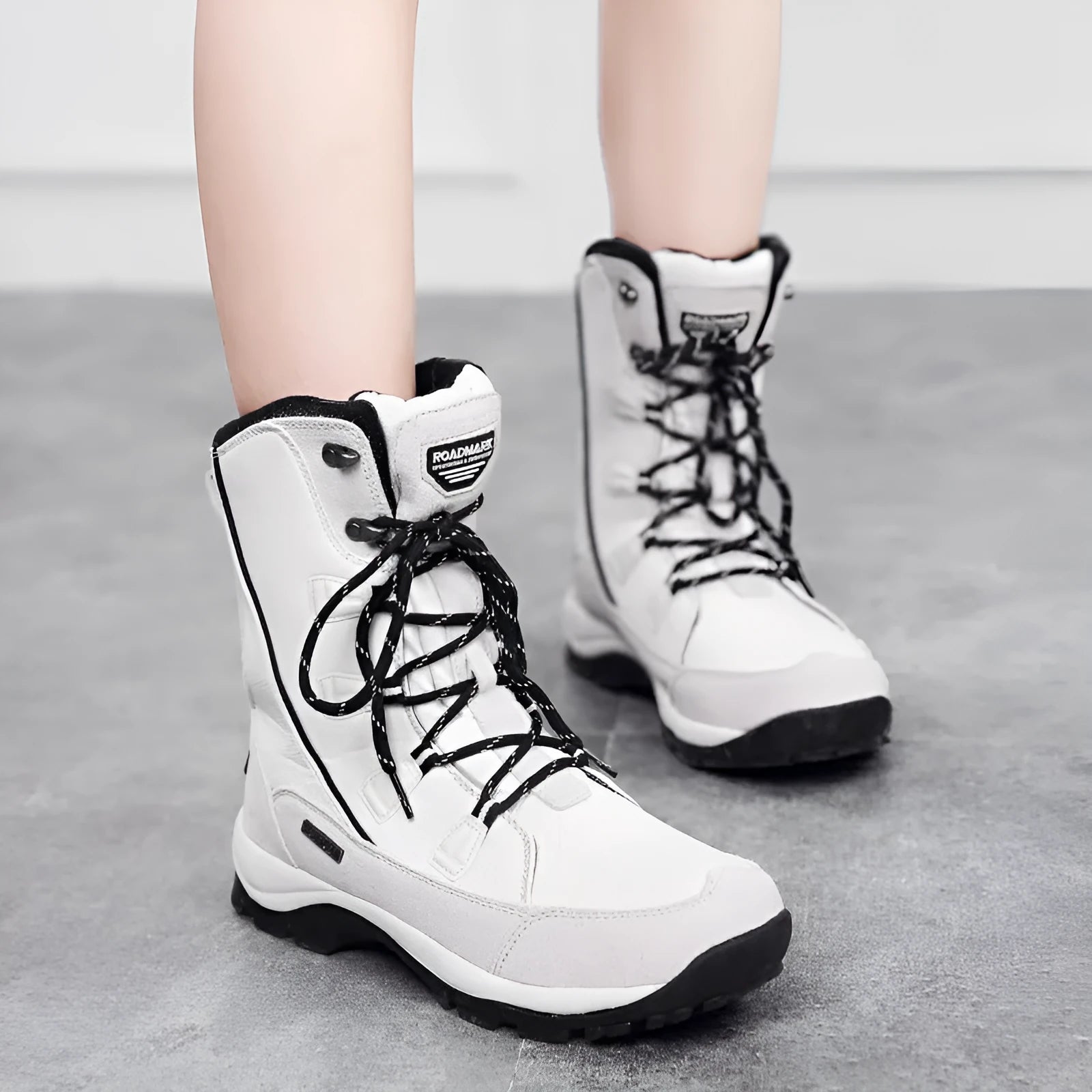 Black women's mid-calf leather snow boots with a round toe and thick rubber sole on a white background.