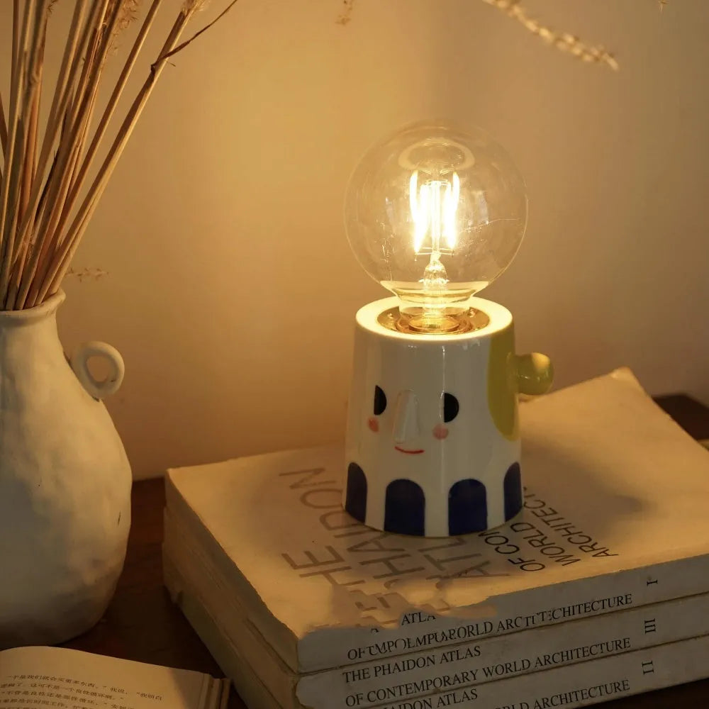 Handmade ceramic lamp with ball headlight design on bedside table