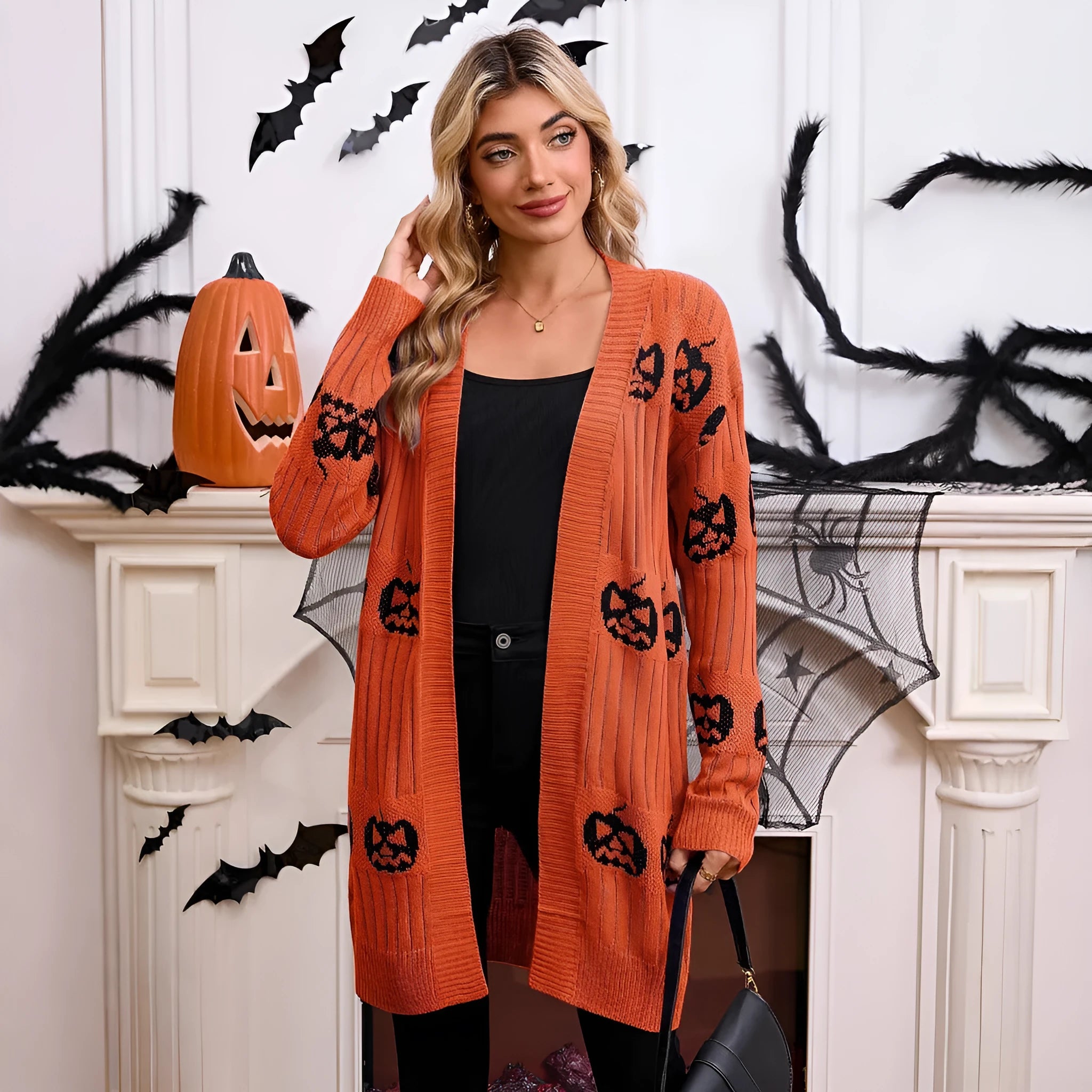 Women's black Halloween cardigan with orange pumpkin head jacquard knit pattern.
