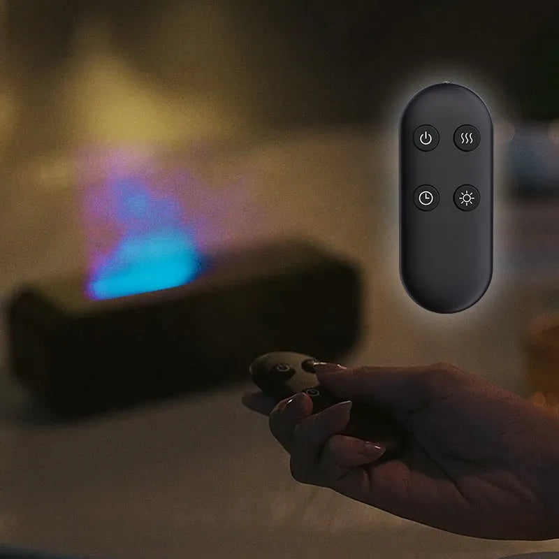Black and white aroma diffuser with remote control on a table, showing colour-changing LED lights.