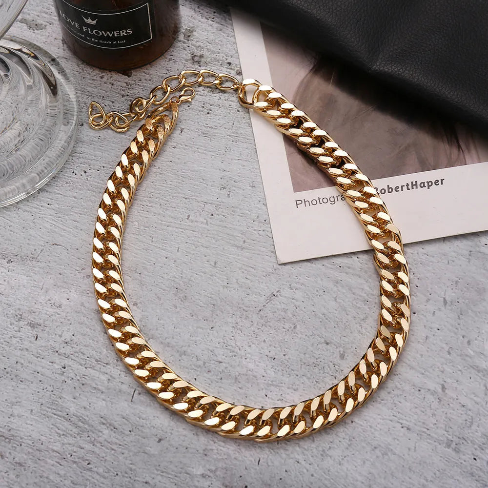 Women's gold thick chain necklace showing 32cm length with 6cm pendant detail