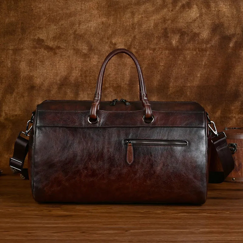 Genuine leather handmade retro travel bag in vintage brown with large capacity.