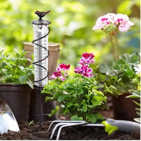 Cast iron hummingbird decoration garden rain gauge with glass measurement tube showing 1-20 scale