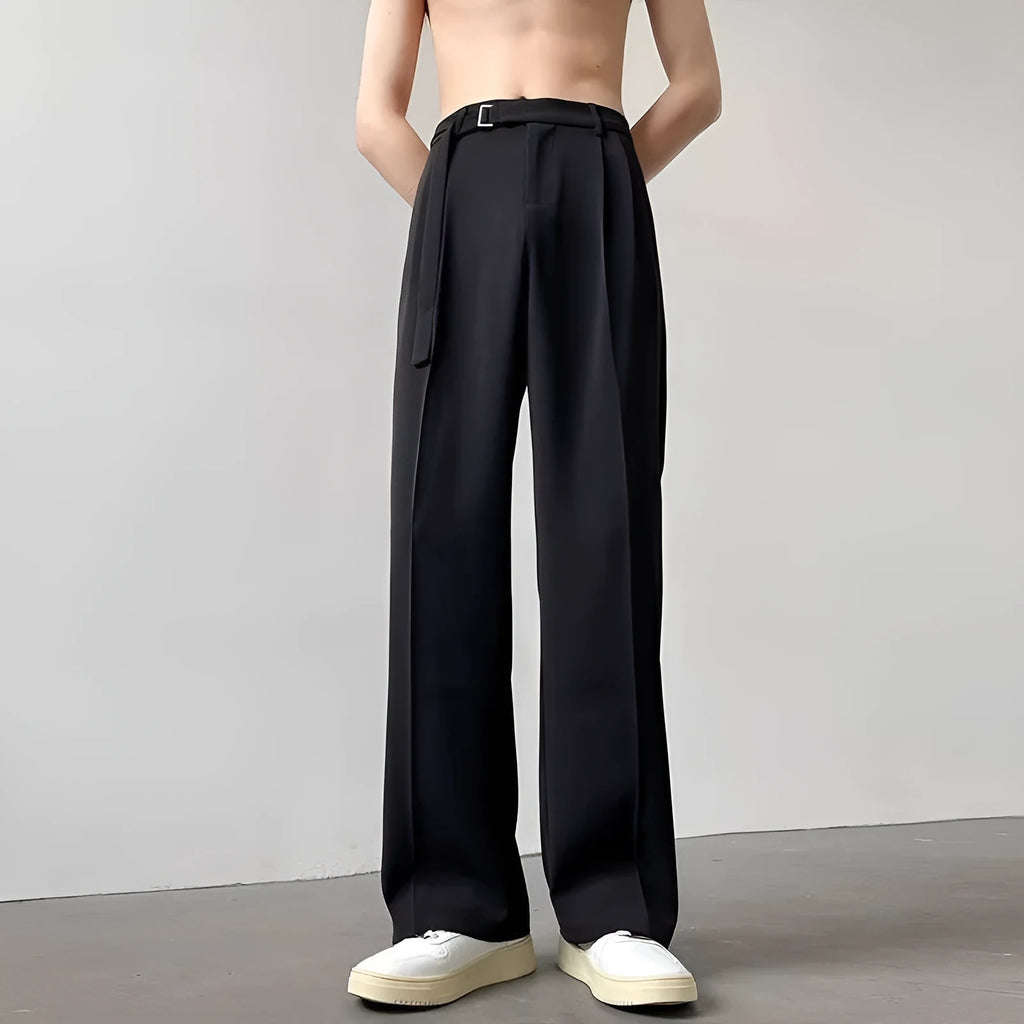 Men's black loose straight-leg trousers with a non-ironing finish on a hanger