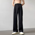 Men's black loose straight-leg trousers with a non-ironing finish on a hanger