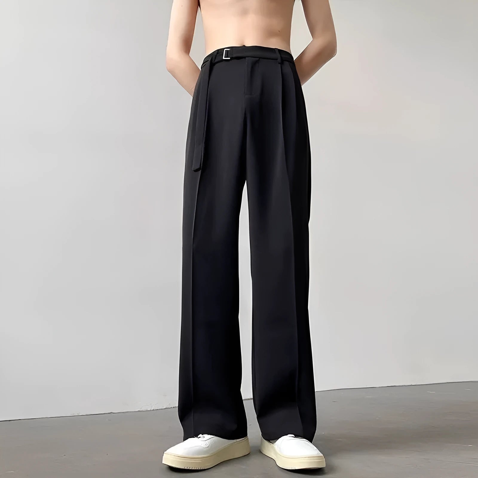 Men's black loose straight-leg trousers with a non-ironing finish on a hanger
