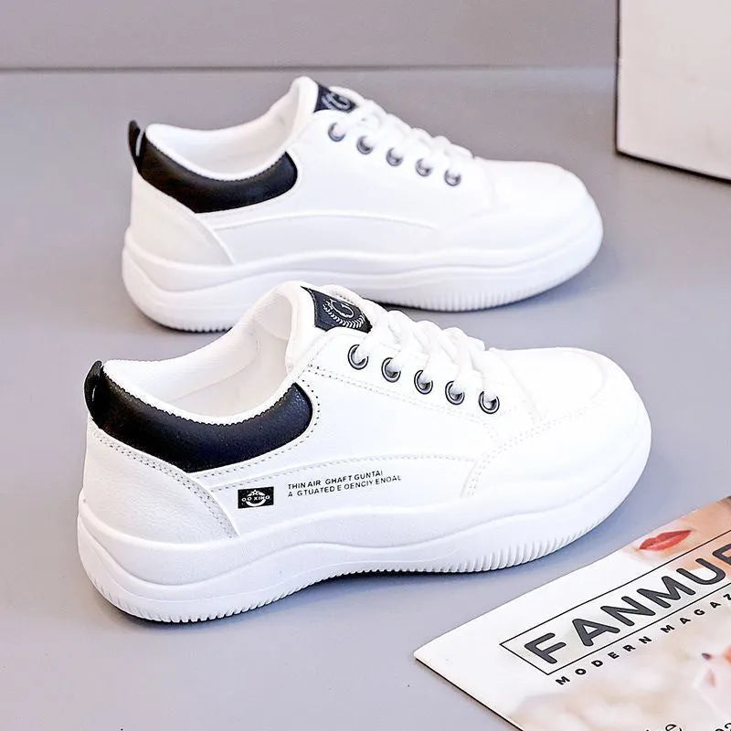 Women's white Korean-style low-top pumps with cross straps and lace-up front on a rubber sole.