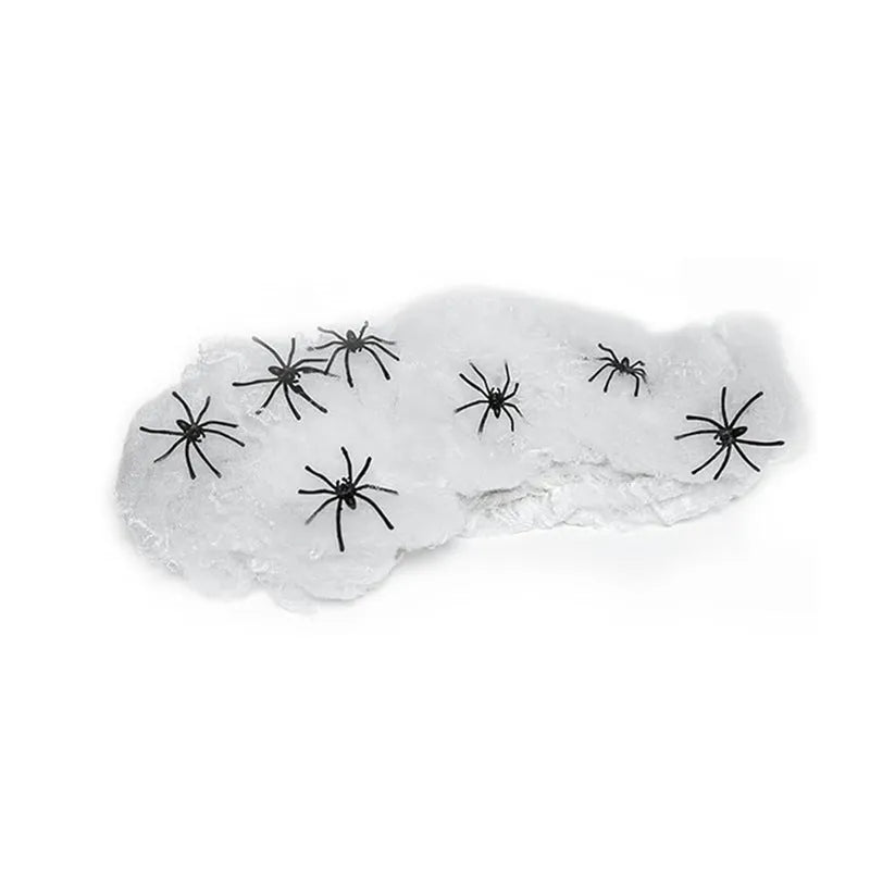 White cotton spider web Halloween decoration props draped across corner with multiple spiders