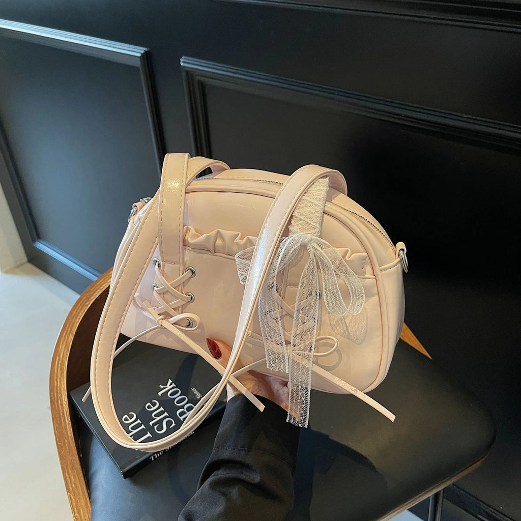 Women's fashion shoulder handbag with bandage bow design in PU leather showing interior phone pocket