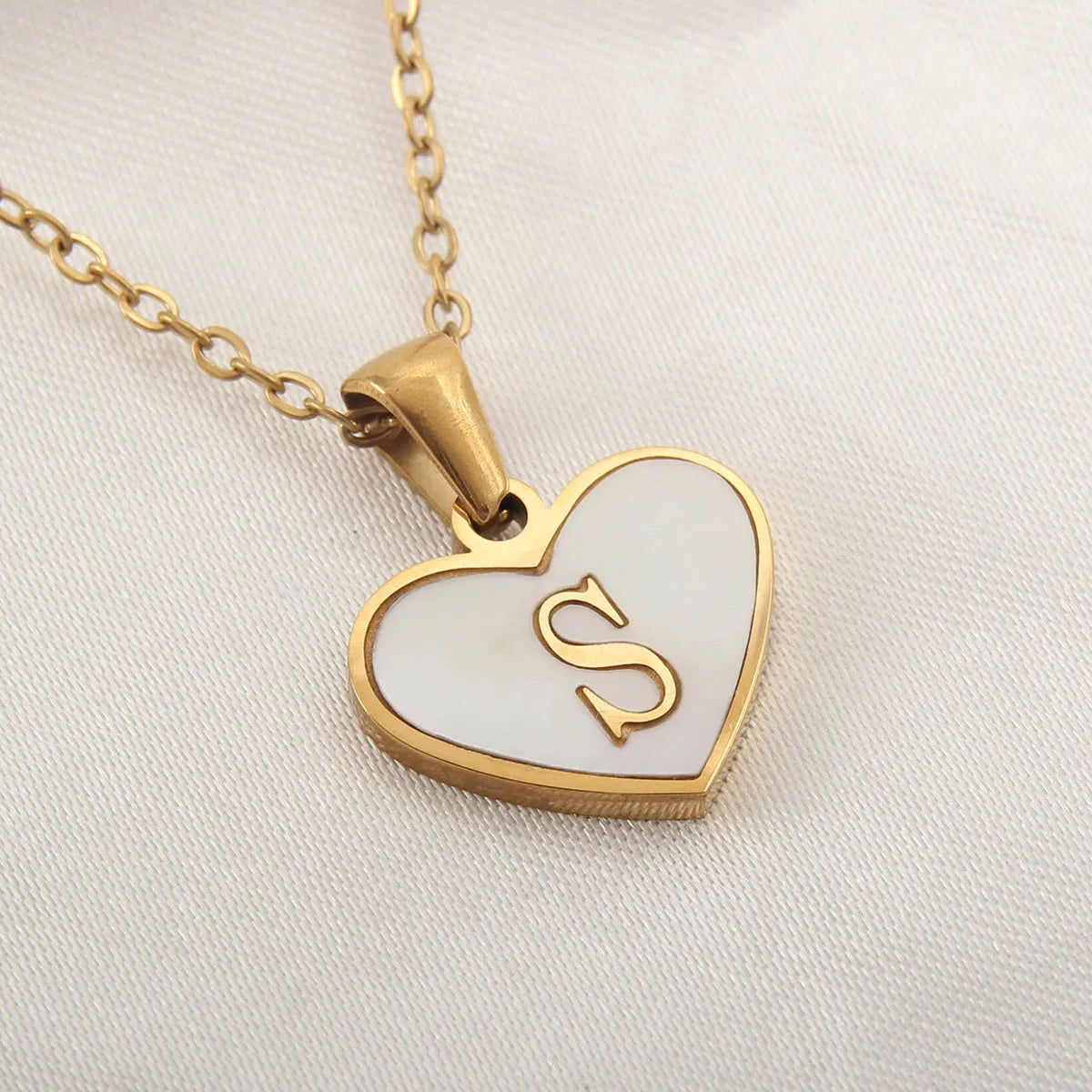 Gold plated heart necklace with white shell detail on an adjustable chain