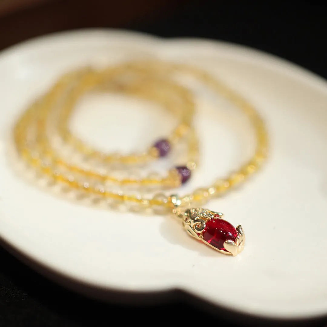 Natural gold rutilated quartz bracelet with three gold rings on wrist