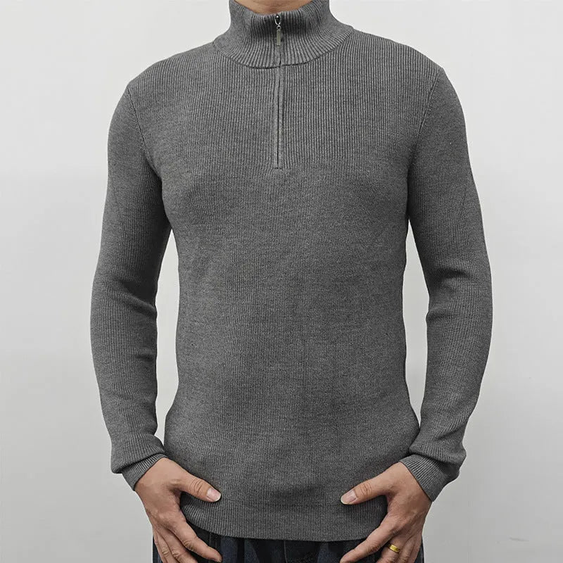 Man wearing a grey zip-up half-turtleneck sweater, a casual cotton blend pullover for leisure.