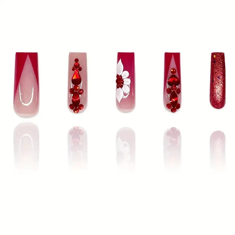 Sweet floral pattern fake nails with prismatic red diamond finish on long European square shape.