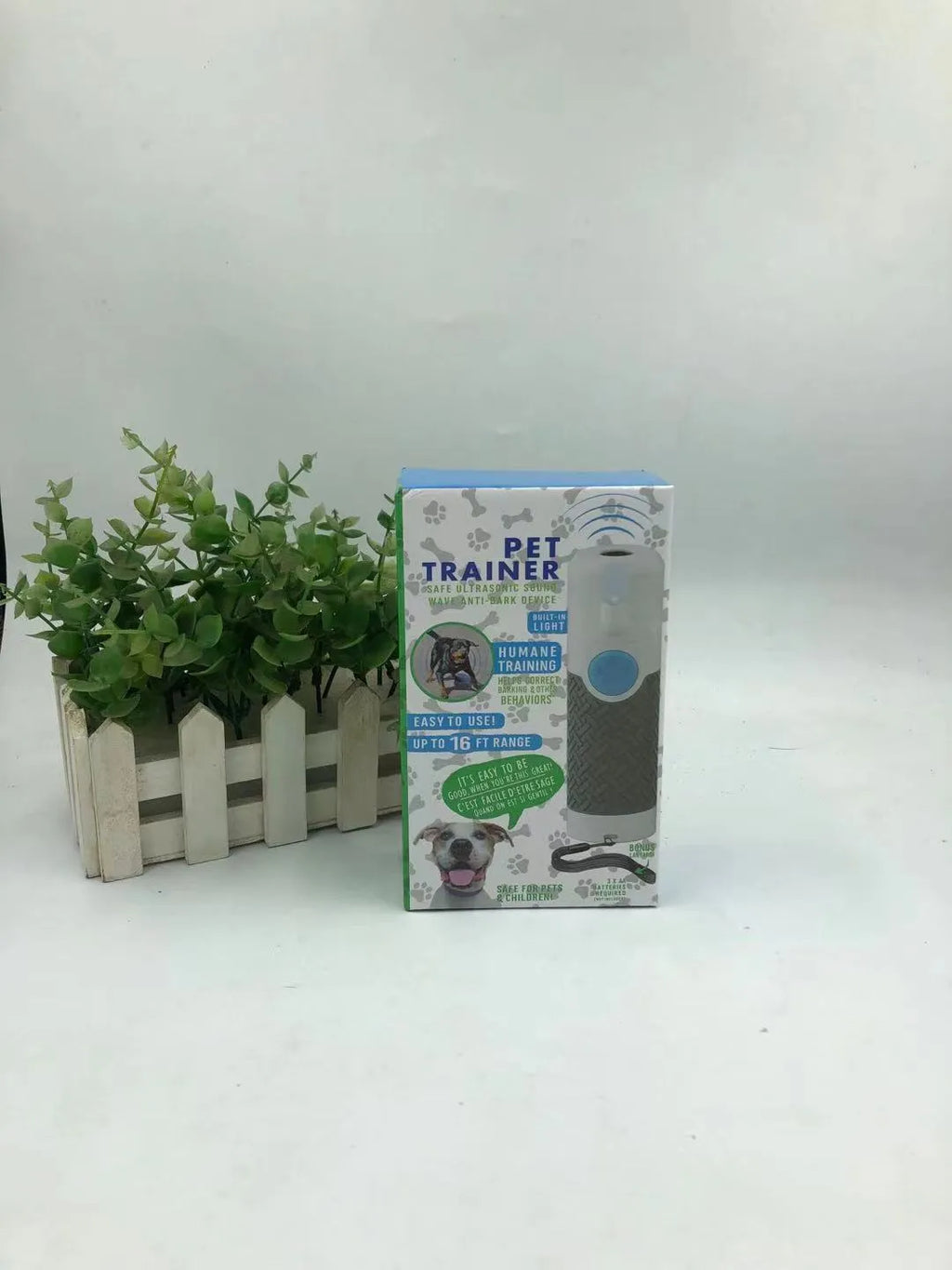 White ABS plastic handheld ultrasonic dog trainer for barking control.