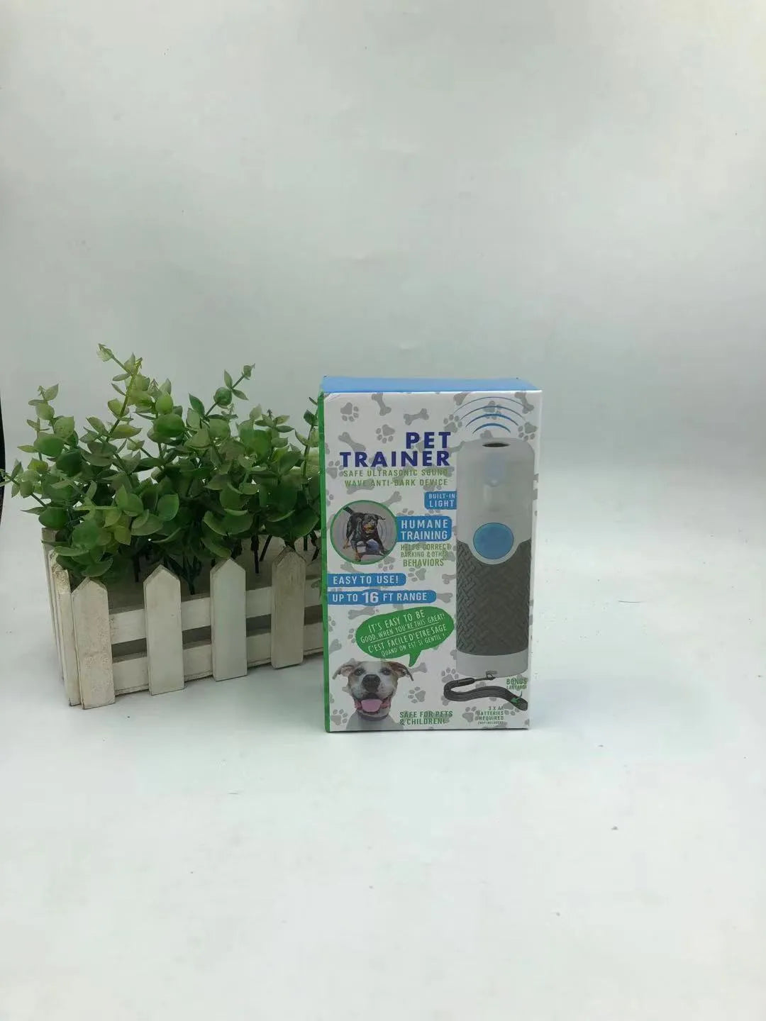 White ABS plastic handheld ultrasonic dog trainer for barking control.