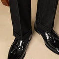 Men's black and brown polished leather tassel loafers with rubber sole
