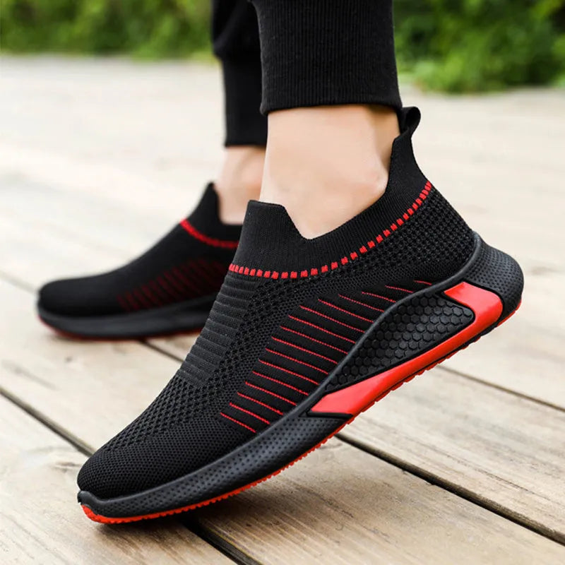Men's black and white striped mesh sock shoes with Flyknit upper and lace-up front.