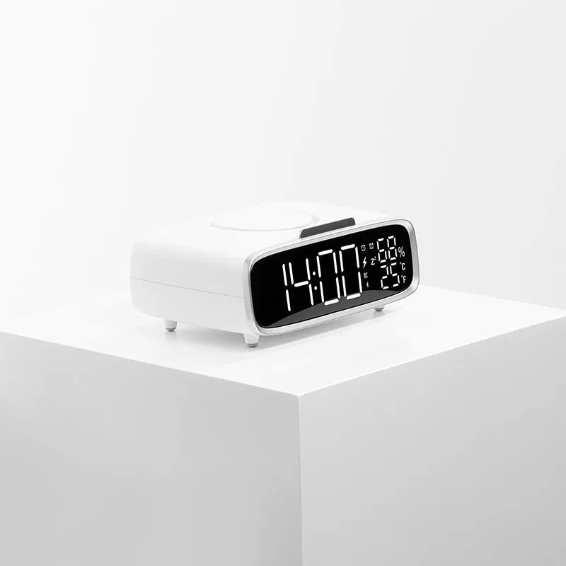 White Bluetooth speaker wireless charger with night light functionality on bedside table