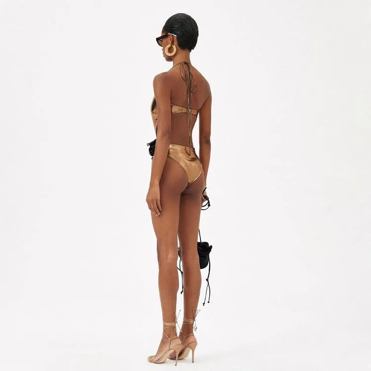 Gold handmade halter one-piece swimsuit with hollow-out design on mannequin
