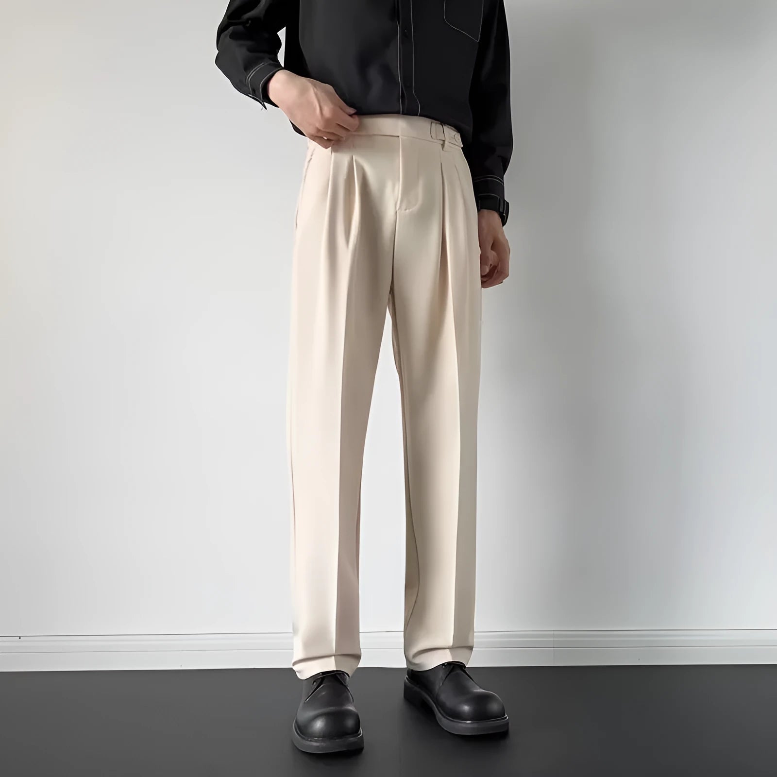 Man wearing apricot coloured straight-leg loose-fit suit pants made from polyester fibre.