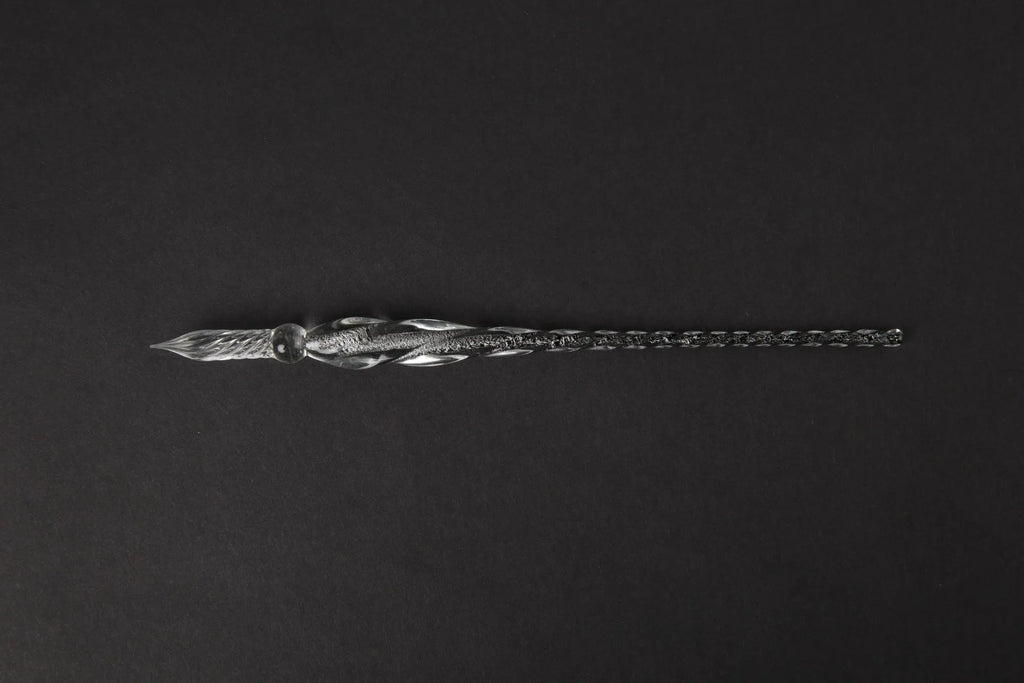 Transparent coloured glaze crystal pen in a gift box, showing abstract glass design.
