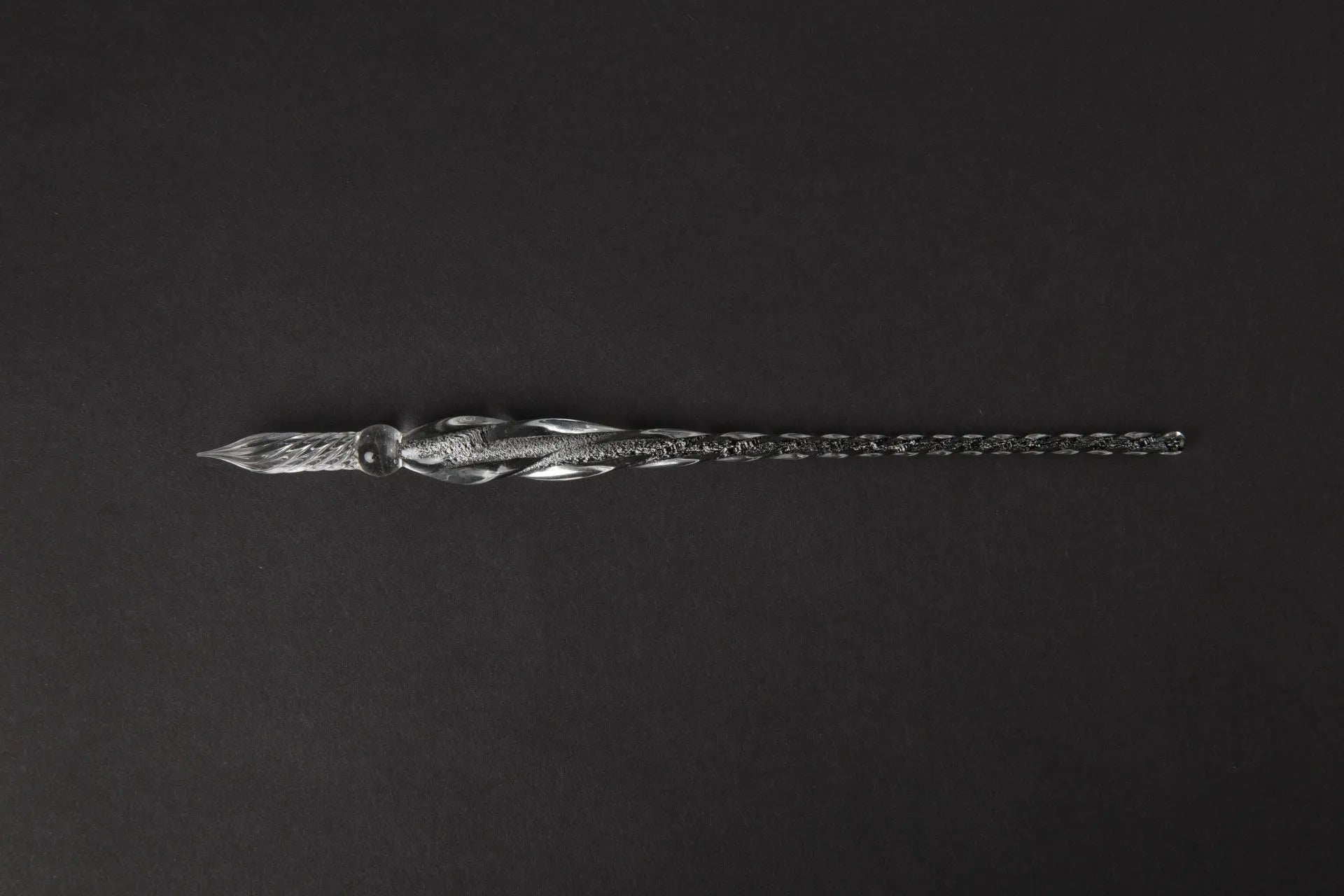 Transparent coloured glaze crystal pen in a gift box, showing abstract glass design.