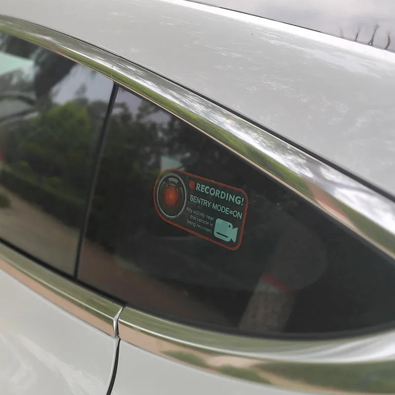 Tesla Sentry Mode warning sticker showing English text on electrostatic PVC material