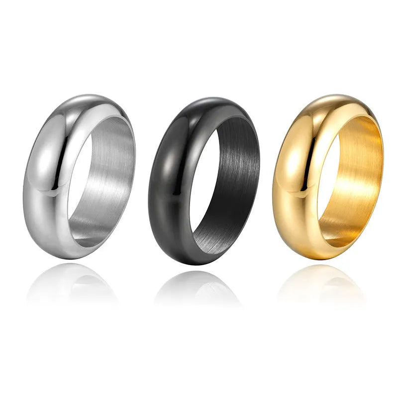 A glossy electroplated titanium steel ring shown in gold, black, and steel colour options on a plain background.