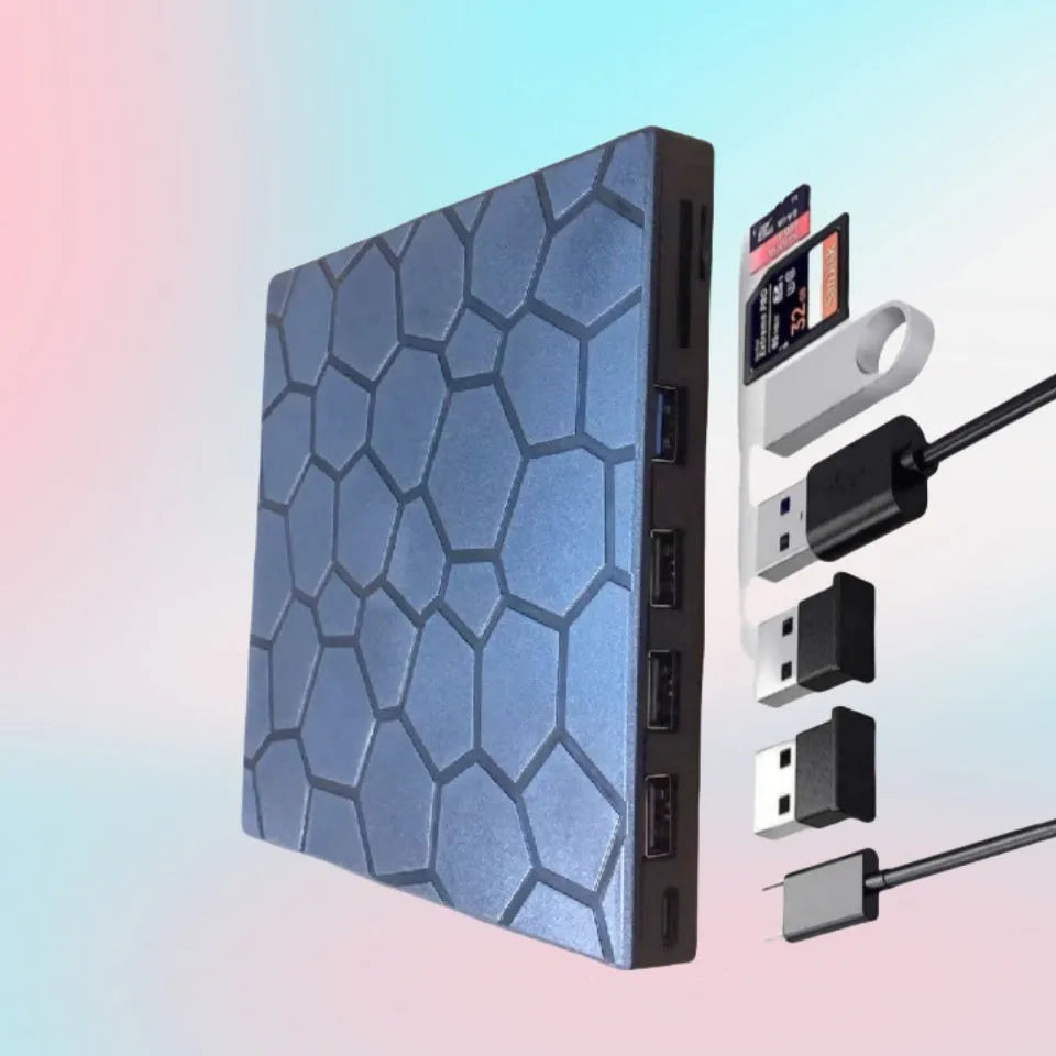Black external USB CD DVD writer drive on a desk next to a laptop