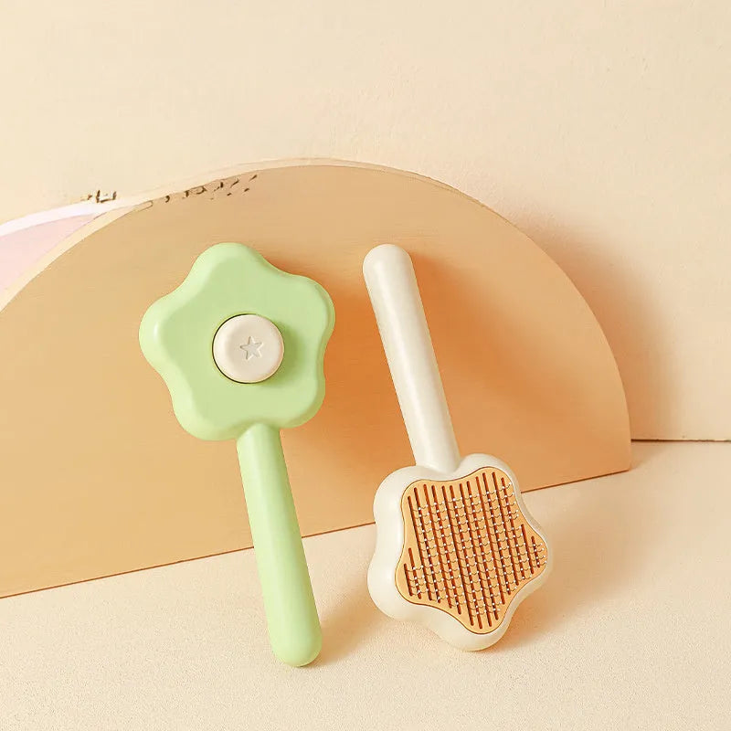 Green and yellow self-cleaning stainless steel cat comb grooming tool measuring 20 cm.