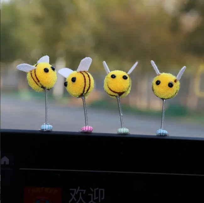 Soft fur bee car decoration on a swing spring for dashboard personalisation.