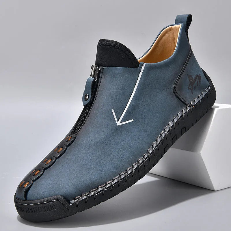 Men's black leather boots with front zipper and hand-stitched detailing, mid-calf height with low rubber sole