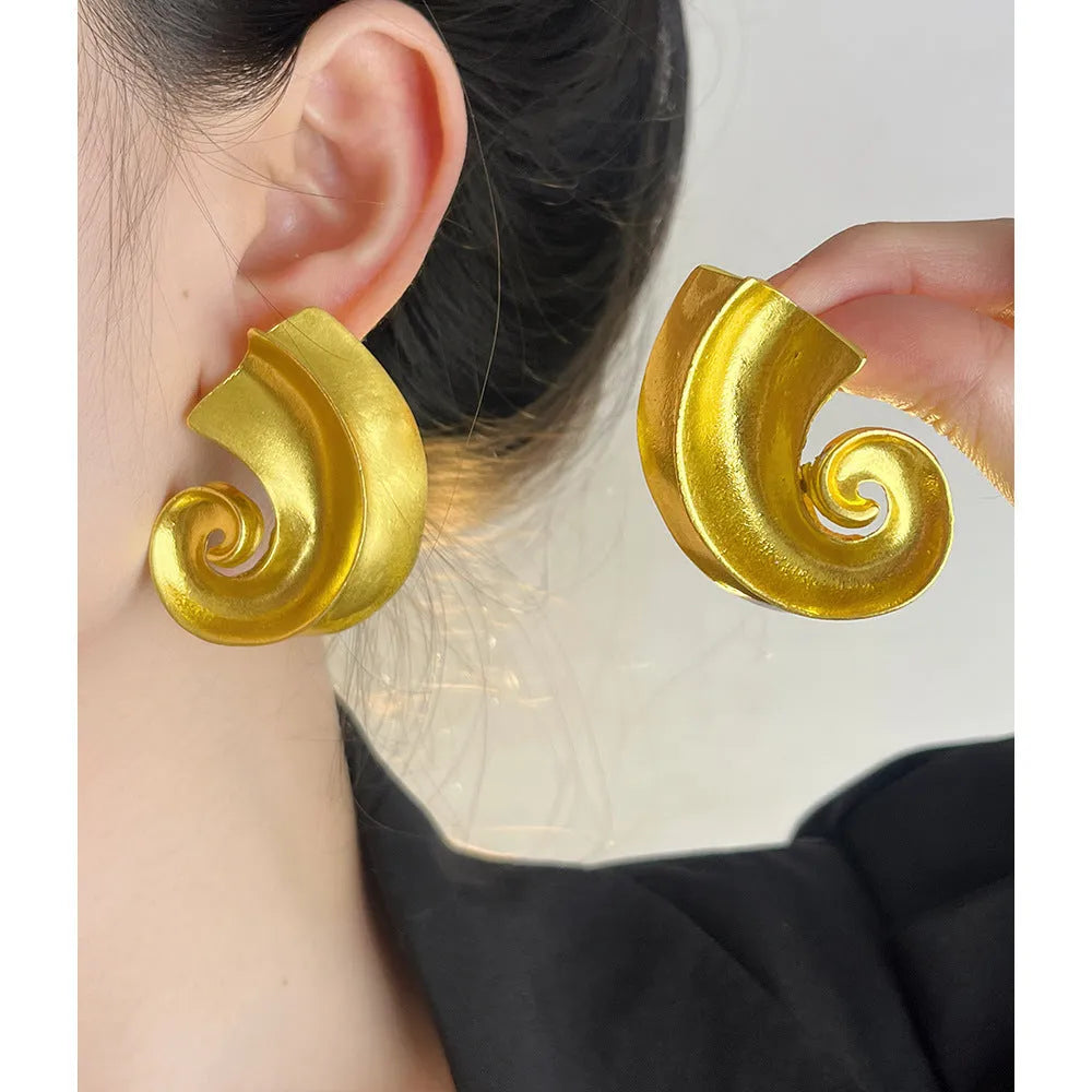 Retro geometric alloy ear studs in gold or silver colours measuring 5cm