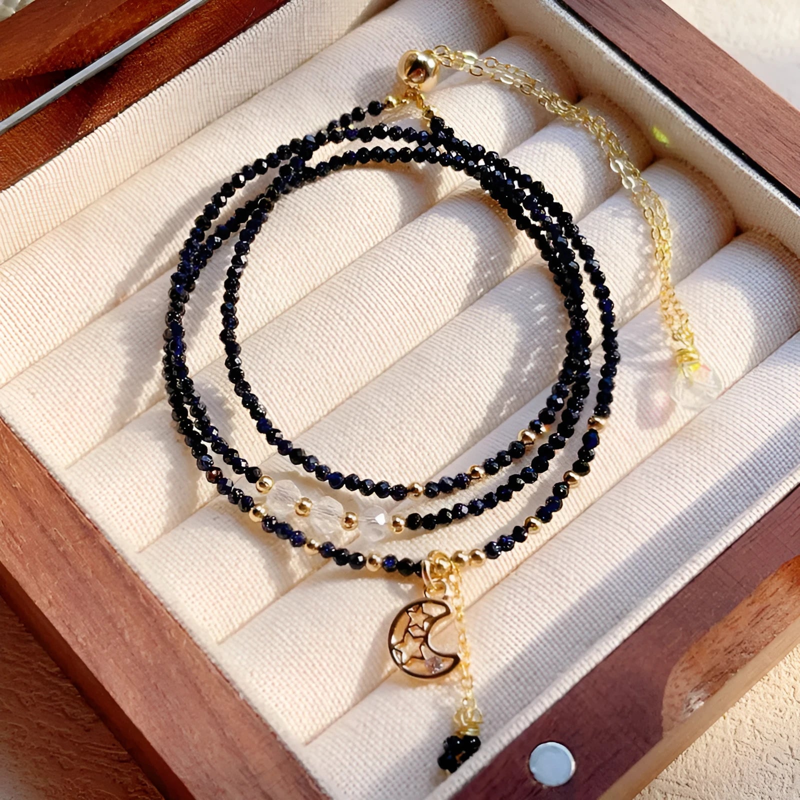 Blue sand stone three-ring multi-layer bracelet for women on a wrist.
