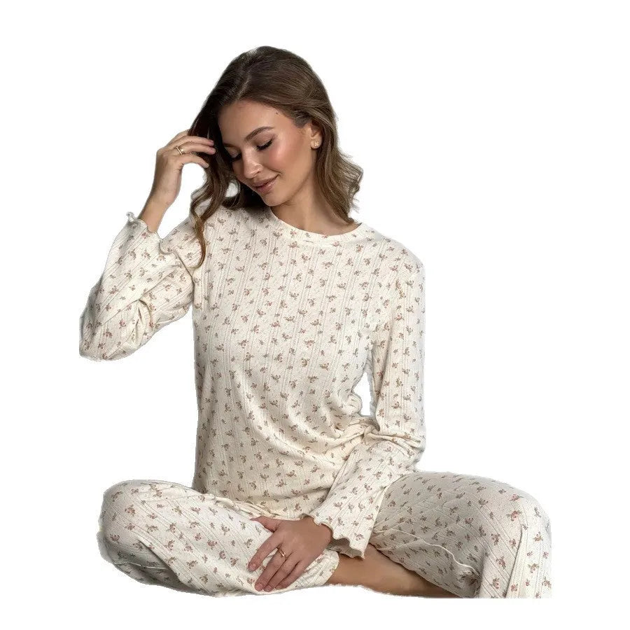 White floral print women's pyjama set with bell sleeve top and wide-leg trousers.